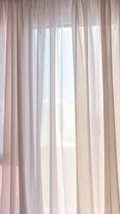 Soft, translucent curtains gently filter the natural light coming through