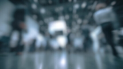 Fototapeta premium Abstract blur background of the Crowds move briskly through a high tech exhibition, surrounded by glowing digital displays reflect the rhythm of urban innovation.