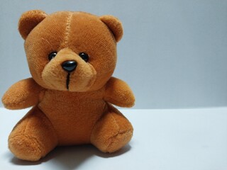 A cute brown teddy bear plush toy photographed on a clean background, ideal for kid-themed content, product display, and online store visuals.