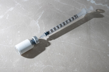 Close up of Small Vial with Medicine or HRT and Single Use Syringe