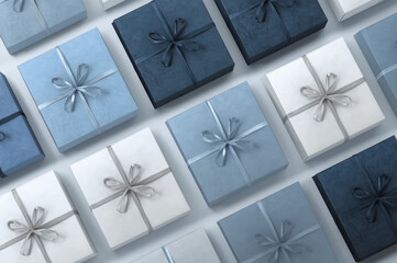Monochrome blue gift boxes with bows arranged in a seamless pattern. Minimal geometric holiday background for wrapping paper and branding mockups.