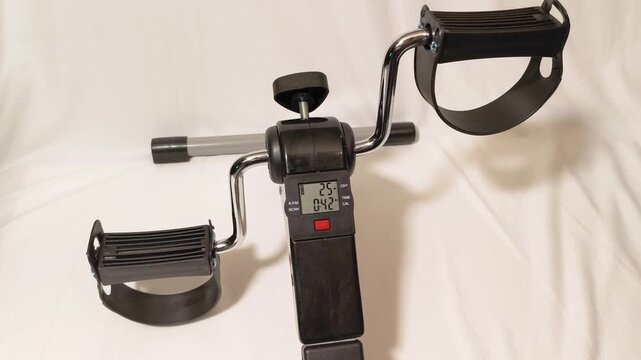 Pedal exerciser showing workout progress and calorie count, perfect for rehabilitation and fitness, promoting healthy lifestyle and active aging at home in comfortable environment