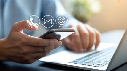 Online Communication: Close-up of a hand using a smartphone, symbolizing modern communication, with communication icons overlayed, representing phone call, email, and online contact.