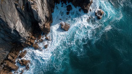 top-down view of rocky cliff edge with crashing waves