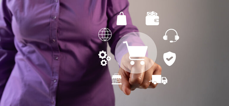 A woman points to a shopping cart icon surrounded by other icons related to online shopping. Concept of shopping and the convenience of online shopping.