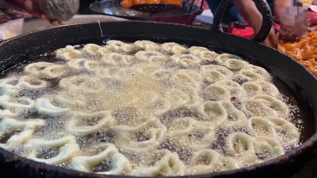 Jalebi being fried in a local shop in the streets of Kolkata during winter