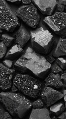 Fototapeta premium Rough black granule texture with irregular crystals and reflective surface, abstract crushed stone material, dark mineral background, ideal for industrial or design concepts