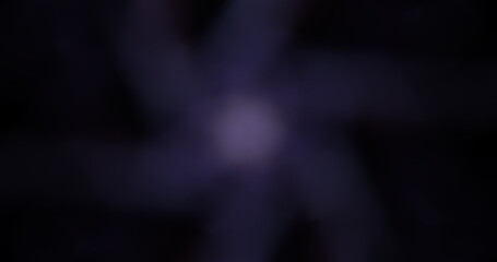 Abstract Dark Purple Bokeh Background with Radial Light Streaks and Central Soft Glow for Dreamy and Mysterious Graphic Design or Overlay