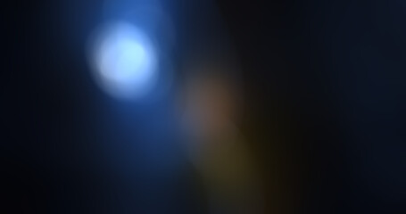 Abstract blue and black background with soft light flares and bokeh effect, modern dark gradient texture with subtle warm light elements for creative design