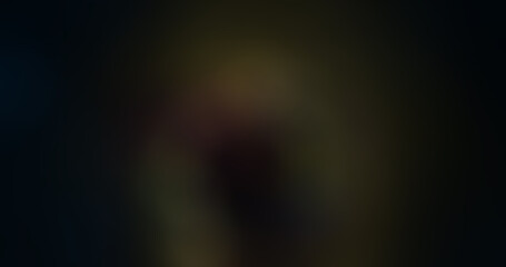 Dark abstract background with subtle light leaks and blurry colorful gradients, creating a moody and atmospheric texture for graphic design or overlay