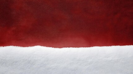 Abstract textured background with a rough torn edge separating deep crimson red and stark white paper