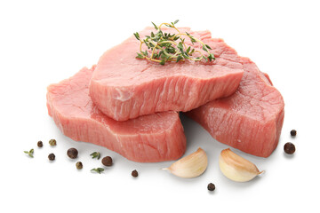 Fresh raw steaks with thyme, garlic and peppercorns on white background