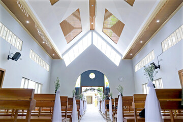 Bright Christian Church Altar and Aisle Decorated for Wedding Ceremony