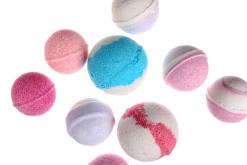 Different bath bombs flying on white background