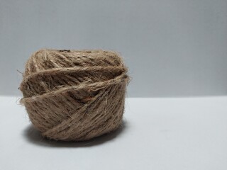 A close-up of a natural jute twine ball on a clean background, ideal for craft projects, packaging themes, and DIY concepts.