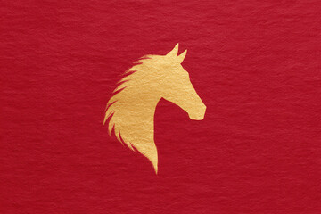 Golden horse head silhouette, elegant and majestic, centered on textured red background, symbolizing strength, power, and prosperity, suitable for decoration or festive design