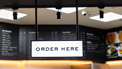 Naklejka premium pickup, order service, and takeaway counter for client of coffee cafe with barista in indoor coffee shop. Fresh morning with hot drink and warm beverage food retail shop