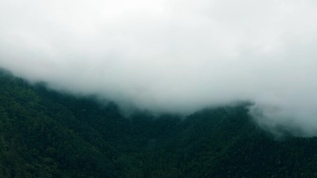 Drone footage shows a view of green mountains shrouded in thick fog that descends low over the mountain peaks in Tawangmangu, Central of Java, on Saturday, October 25, 2025.