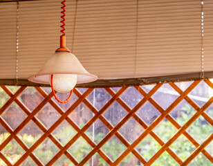 A lamp hangs from the ceiling on the veranda of the cafe.