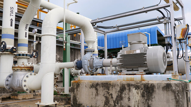 industrial pump and pipe system, factory water supply lines, mechanical pump setup, steel pipeline network, industrial fluid control