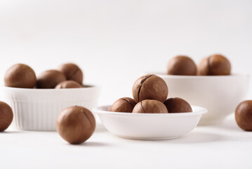 Fresh organic macadamia nuts on white background