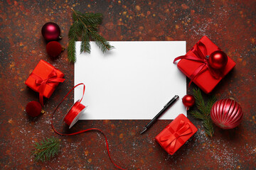 Blank greeting card with Christmas decorations, gift boxes and ribbon on grunge brown background