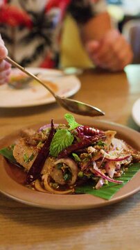 Serving Spicy Thai Pork Salad on Banana Leaf Plate