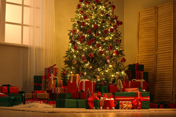 Interior of festive room with Christmas tree, folding screen and many gift boxes at night