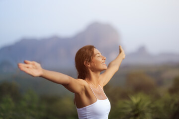 Peaceful Woman Embracing Sunrise In Krabi, Thailand With Arms Outstretched