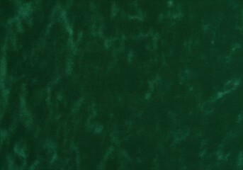 Luxurious dark green velvet cloth texture background with subtle light variations