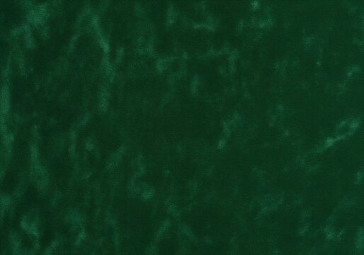 Luxurious dark green velvet cloth texture background with subtle light variations