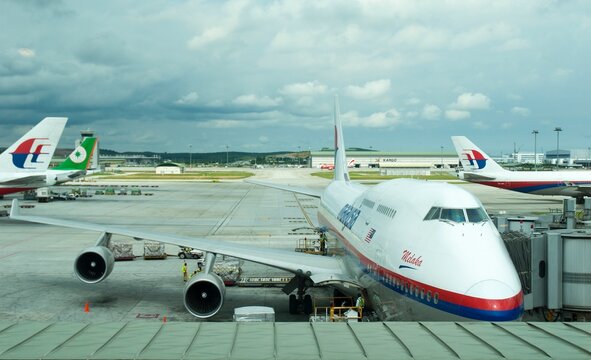 Malaysia Airlines Boeing 747-400 jumbo jet prepares for passengers to board, as ground crew prepares the plane for the flight  in KLIA, Sepang, Malaysia.