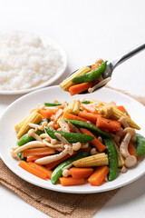 Stir fried vegetables, Green pea, Carrot, Baby corn and Shimeji mushroom with soy sauce, Asian vegetarian food, Healhty eating