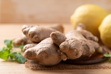 Fresh ginger and lemon on wooden background