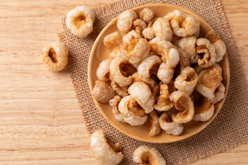 Pork rind on a wooden plate, Northern Thai food, Table top view