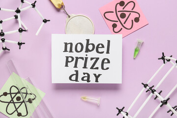 Paper with text NOBEL PRIZE DAY, molecular models, drawn molecules and medal on purple background
