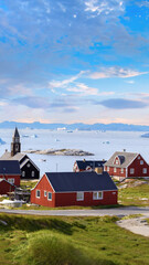 Typical architecture of Greenland Ilulissat with colored houses located near fjords and icebergs. © eskystudio