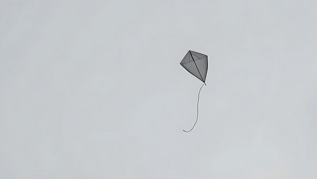 Single kite with a broken string drifting in a grey sky, minimalist composition.