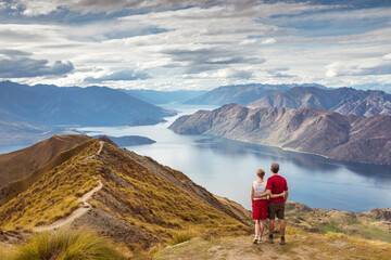 Tourist couple looking at view, Mt Roy, Wanaka, New Zealand