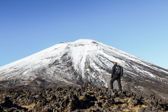 Man looking up at Ngauruhoe volcano, Tongariro, New Zealand