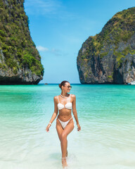 Stylish Woman in White Bikini Walking on Exotic Maya Bay Beach in Thailand