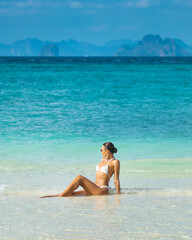 Luxury Bikini Model Sitting in Shallow Water at Exotic Bamboo Island Thailand