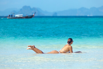 Woman in White Bikini Relaxing in Shallow Water at Bamboo Island Thailand