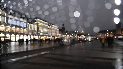 Blurred view of piazza san marco in venice, italy, on a rainy day, with reflections on the wet pavement and lights creating a bokeh effect
