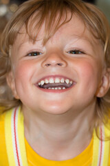close-up of a surprised little blond boy in yellow clothes