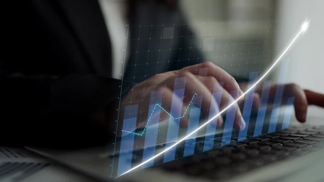 A business professional focuses on financial data analysis with a laptop, showcasing an upward trend through a digital graph overlay, symbolizing growth and success. Copula