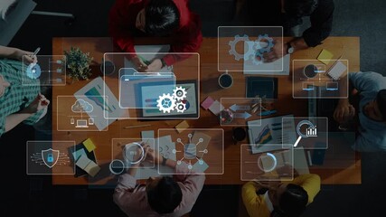 A modern business meeting showcasing a group of diverse individuals collaborating over digital interfaces, data charts and strategic discussions in a professional workspace. Raster - Powered by Adobe