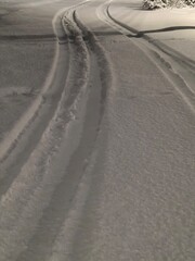 Tire tracks in fresh snow on Russian winter road at night