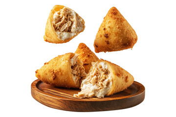 Crispy Brazil coxinha snack filled with shredded chicken croquettes and creamy cheese on wooden plate, isolated on white transparent background, concept of South American Cuisine
