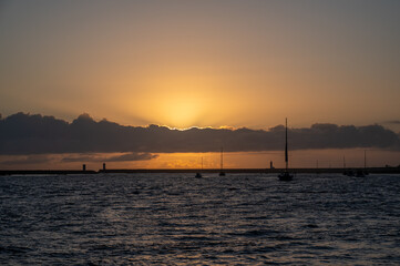 Fototapeta premium Felgueiras lighthouse on breakwater at mouth of Douro River in Porto, Portugal at sunset.